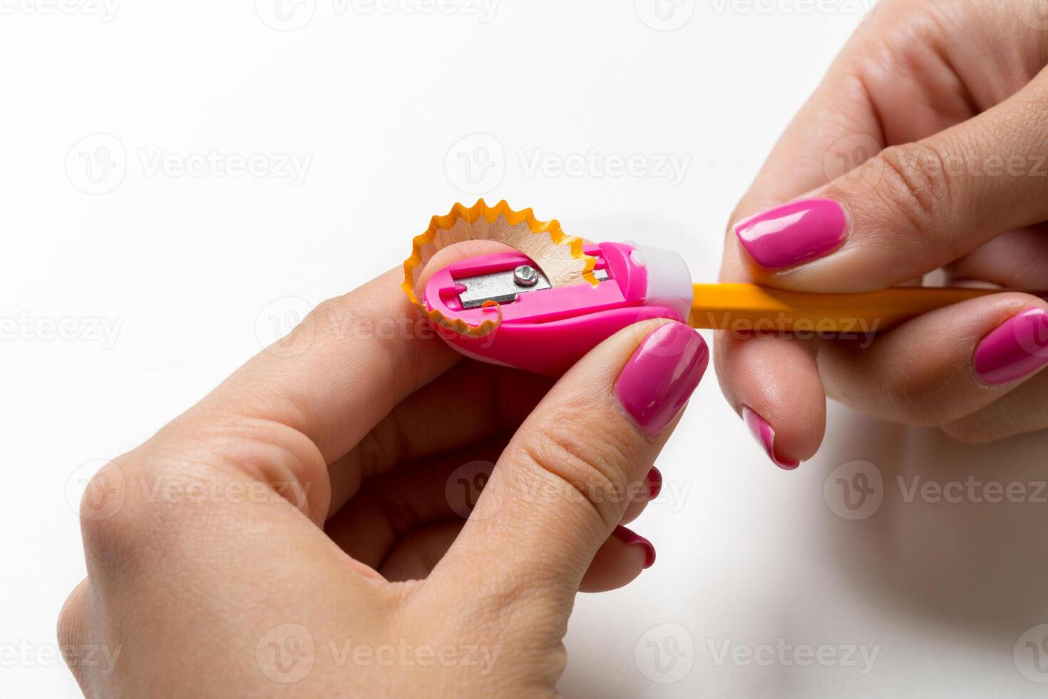 Woman is sharpening the pencil photo