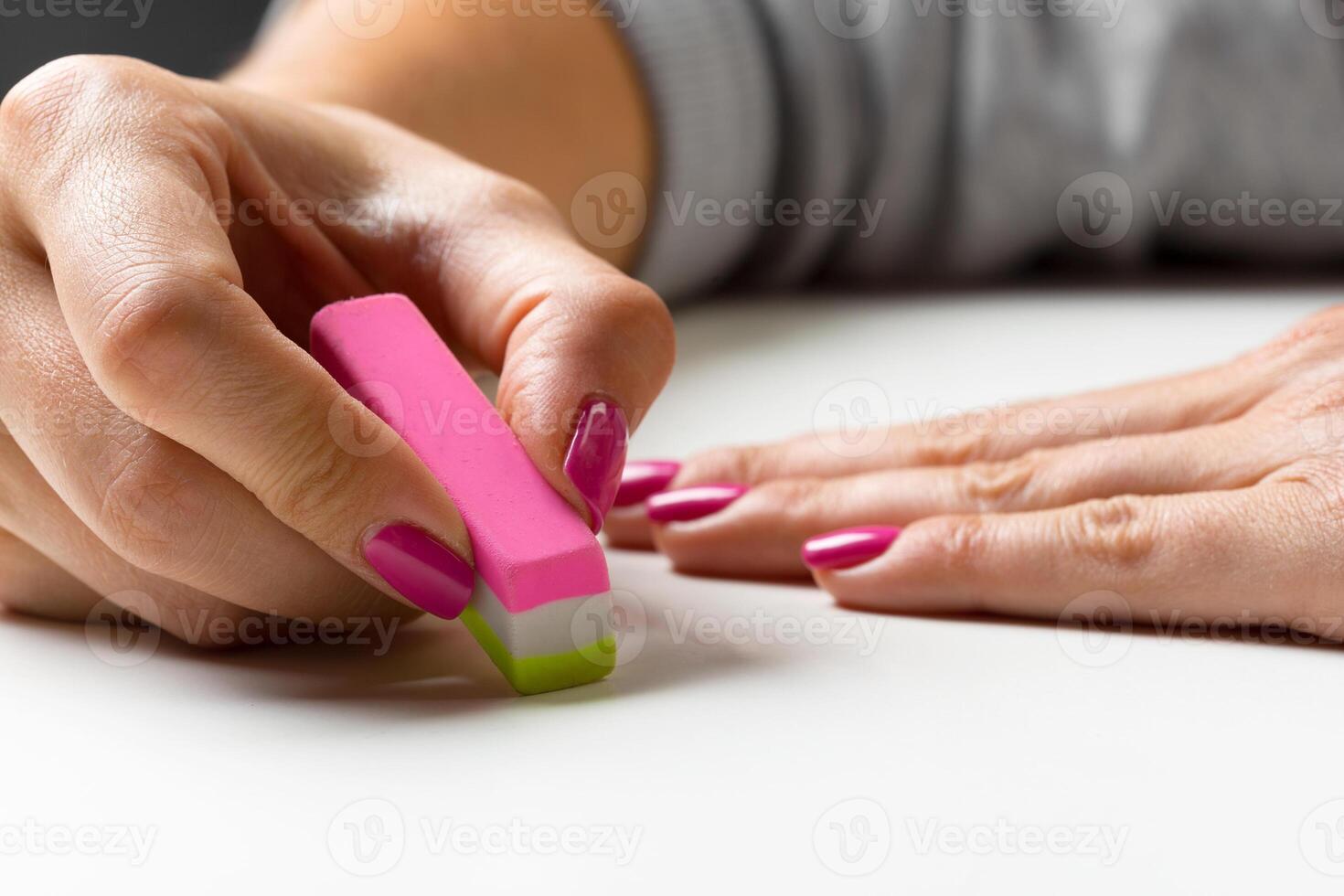 side view of hand with rubber eraser photo