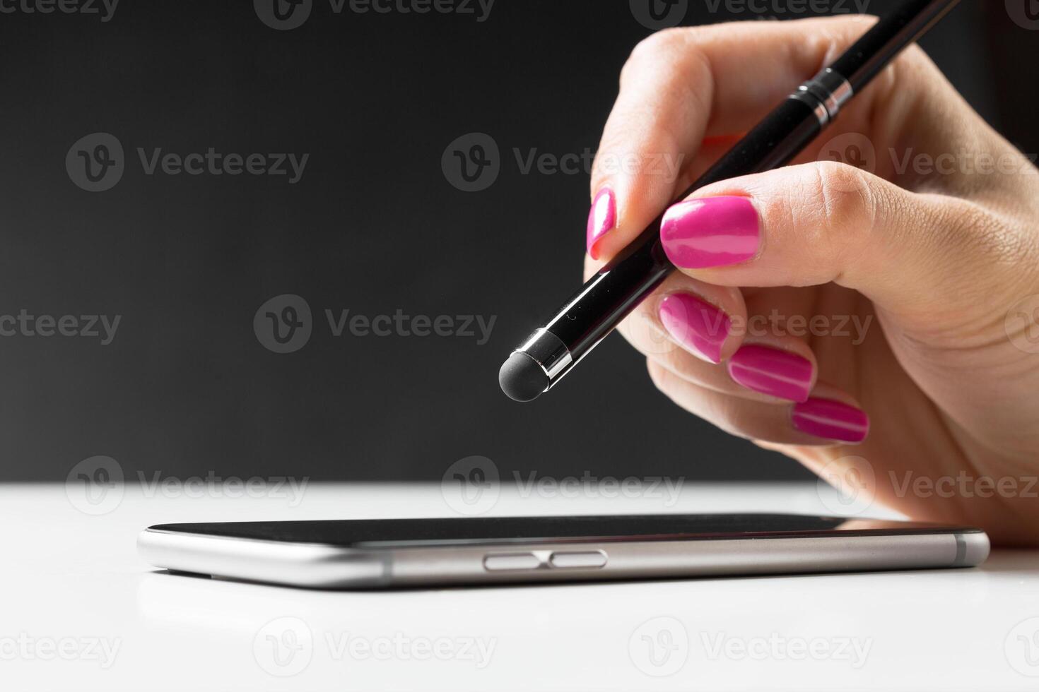 woman working with pen on smart mobile phone photo