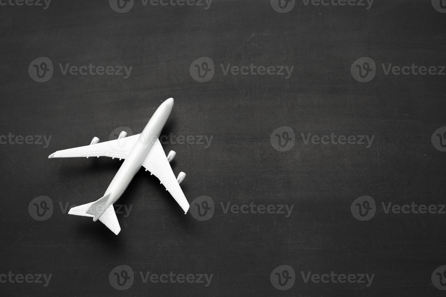 Miniature airplane on black background photo