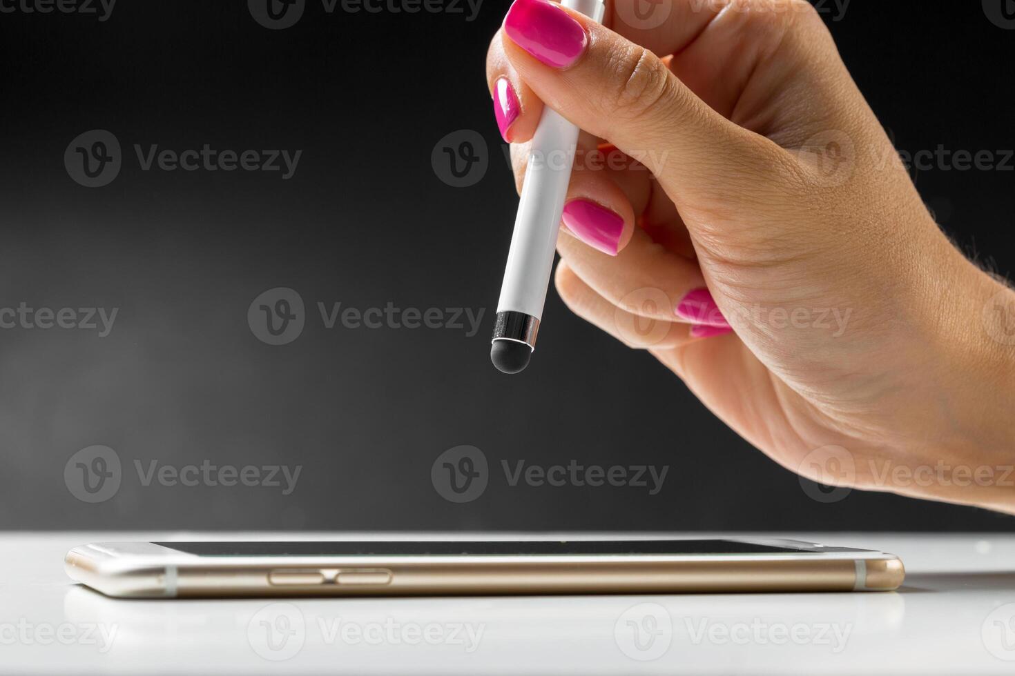woman working with pen on smart mobile phone photo