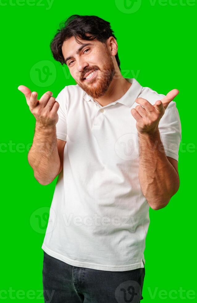 Smiling man gestures playfully with finger guns against a vibrant green background photo