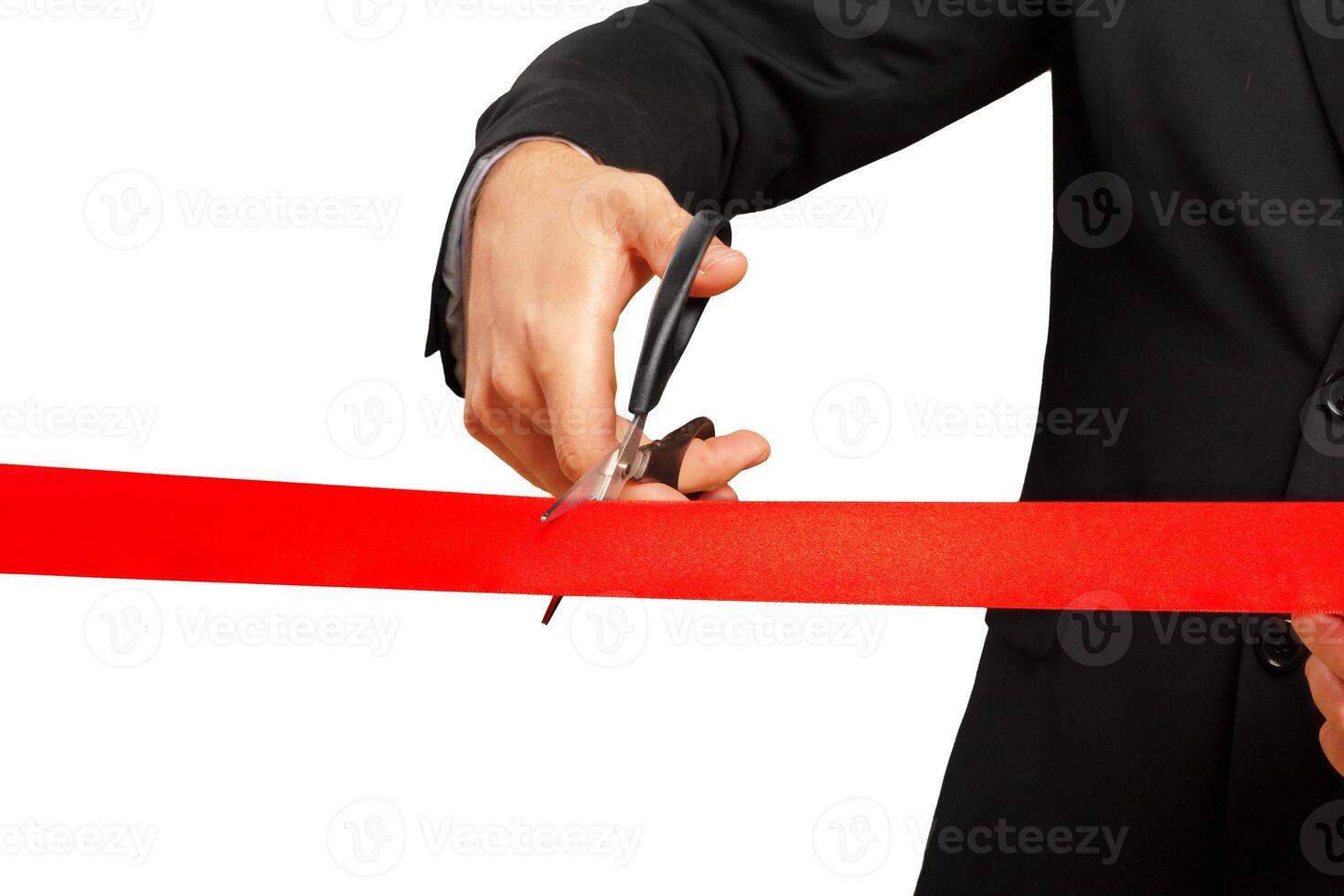 Scissors are cutting red ribbon or tape. Isolated on white background. photo