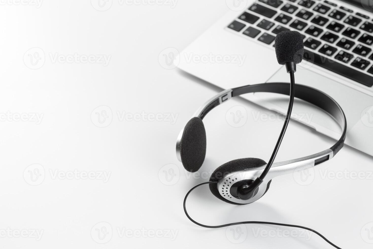 call center support concept. headset on keyboard computer laptop photo