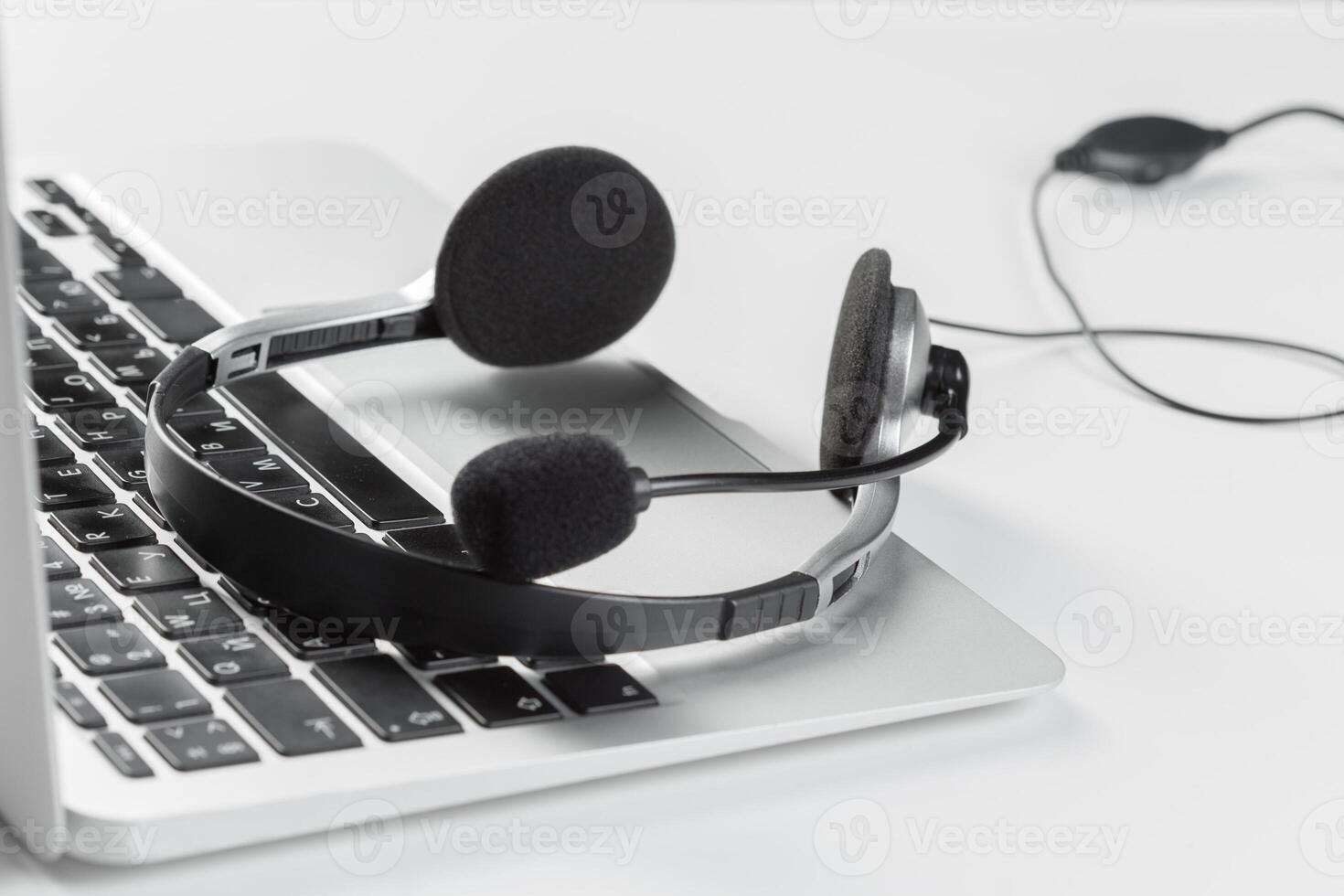 call center support concept. headset on keyboard computer laptop photo