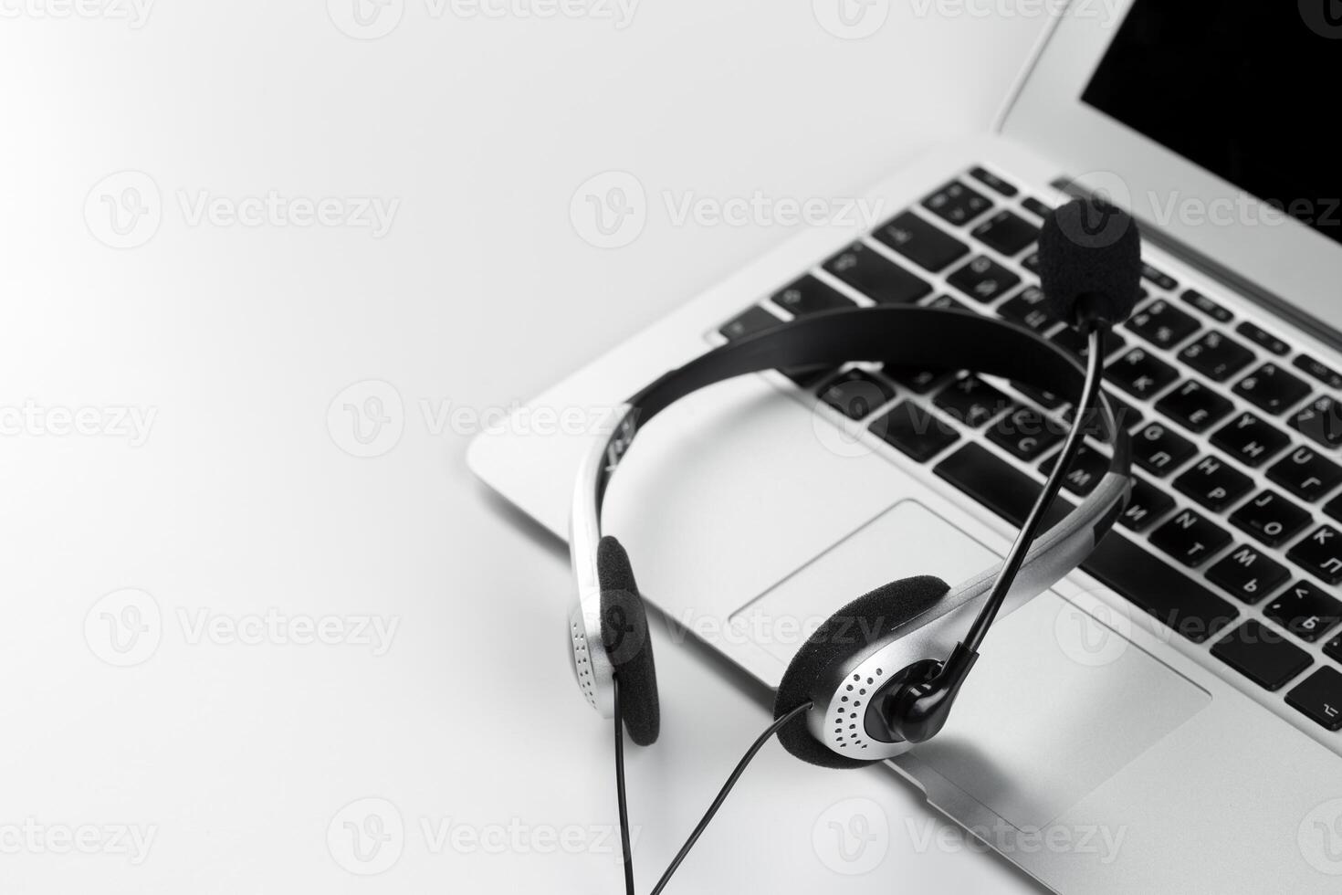 call center support concept. headset on keyboard computer laptop photo
