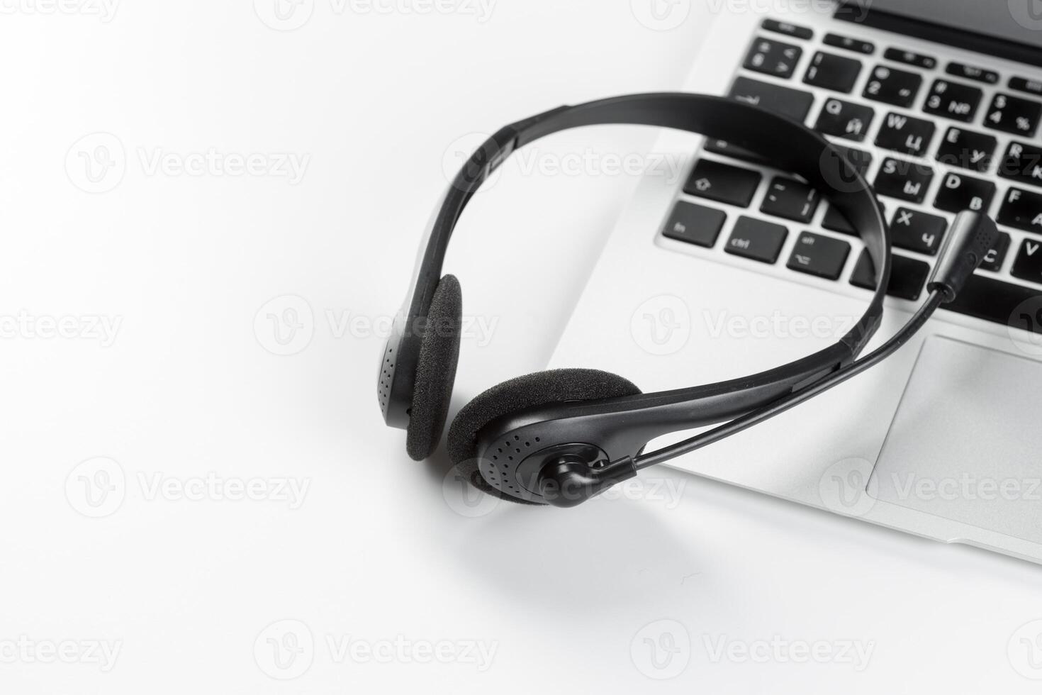 call center support concept. headset on keyboard computer laptop photo