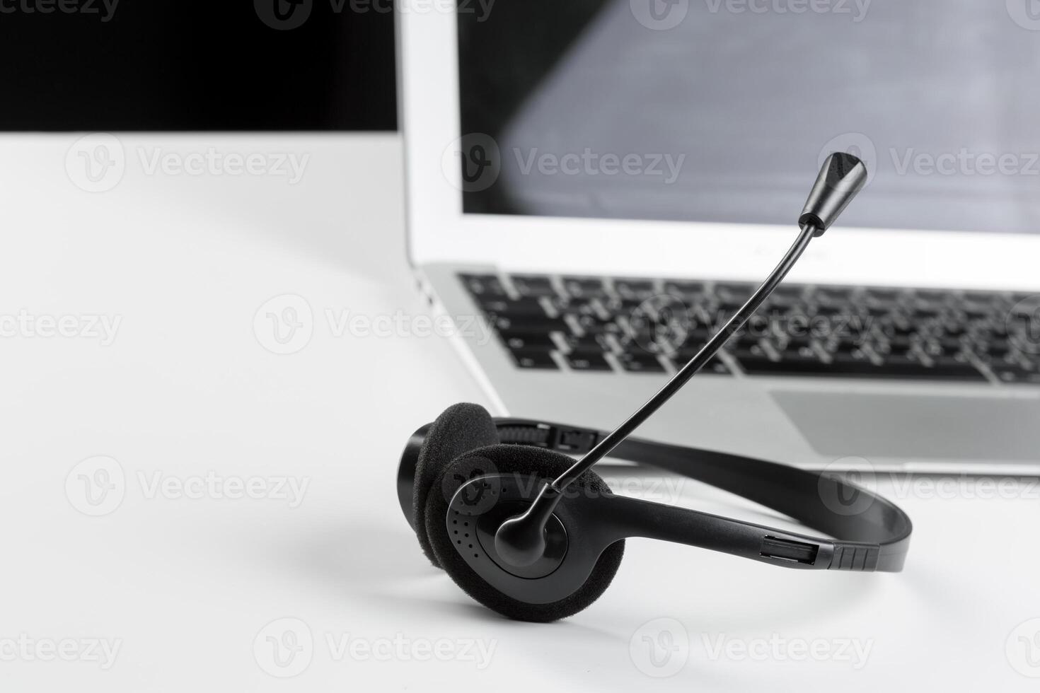 call center support concept. headset on keyboard computer laptop photo