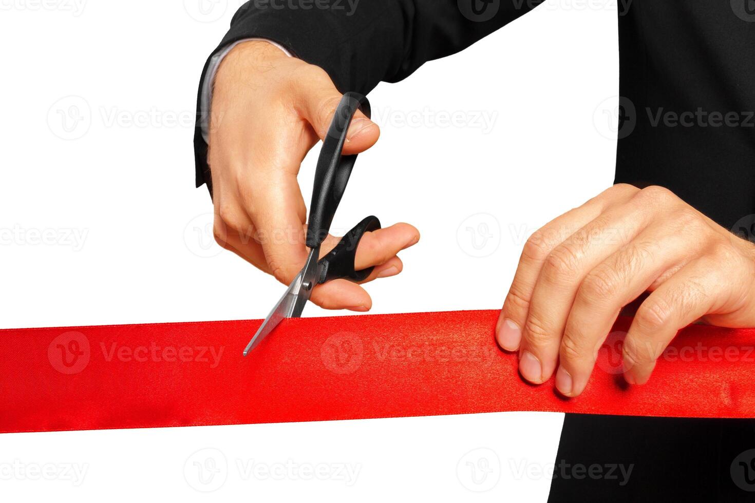 Scissors are cutting red ribbon or tape. Isolated on white background. photo