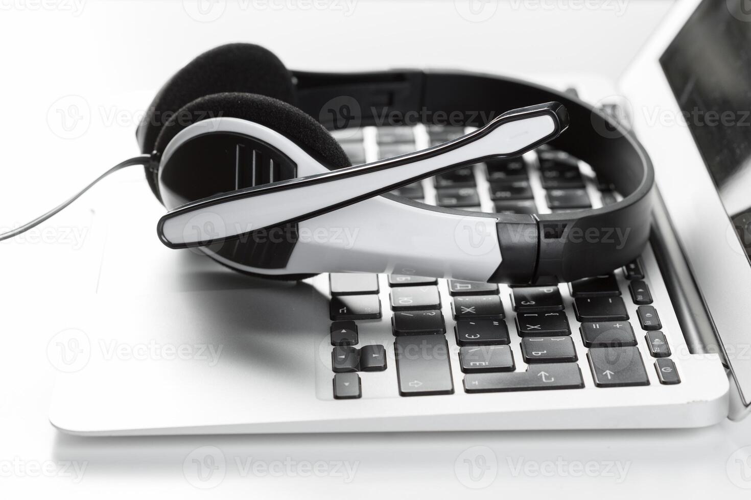 call center support concept. headset on keyboard computer laptop photo