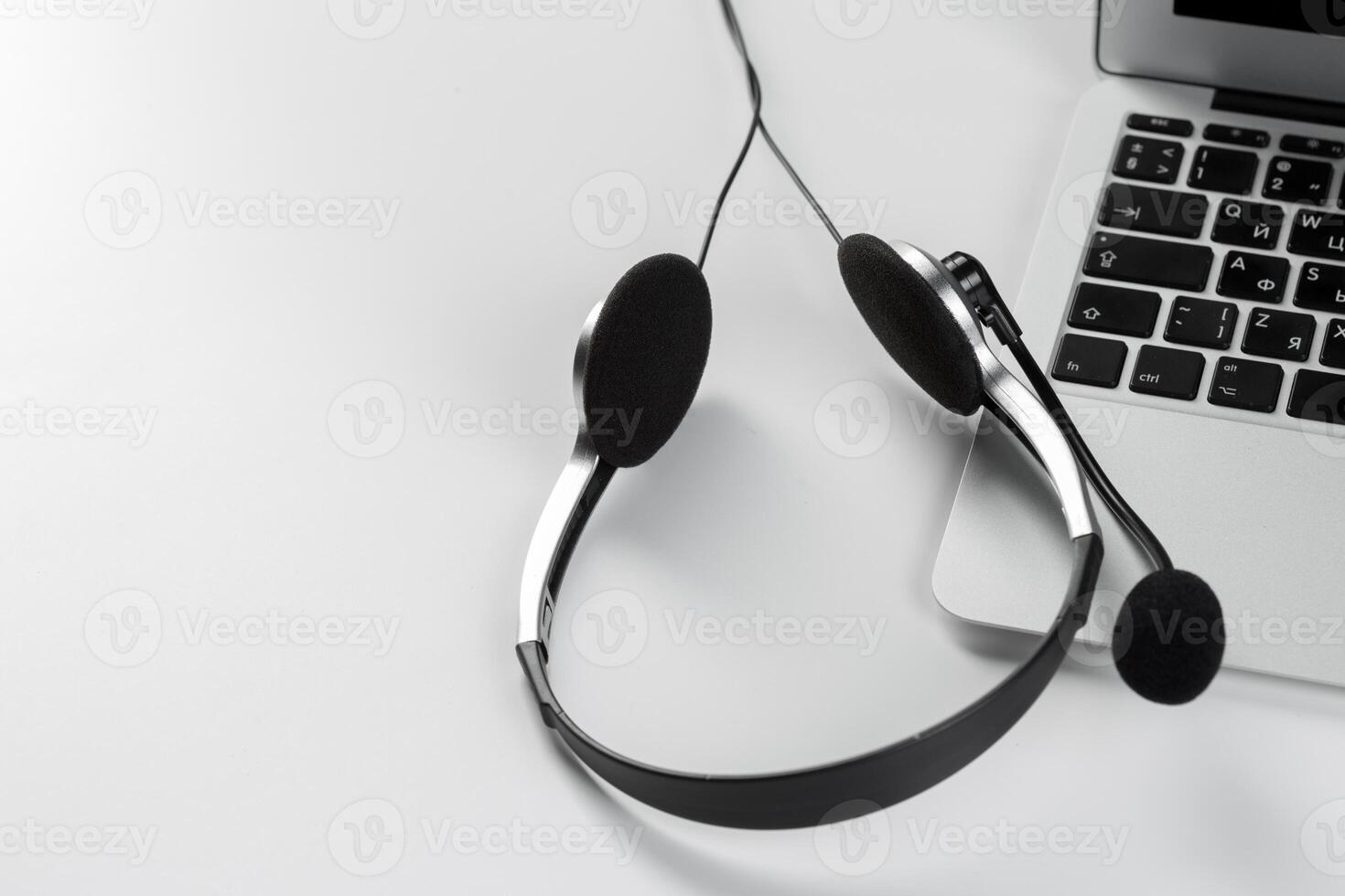 call center support concept. headset on keyboard computer laptop photo