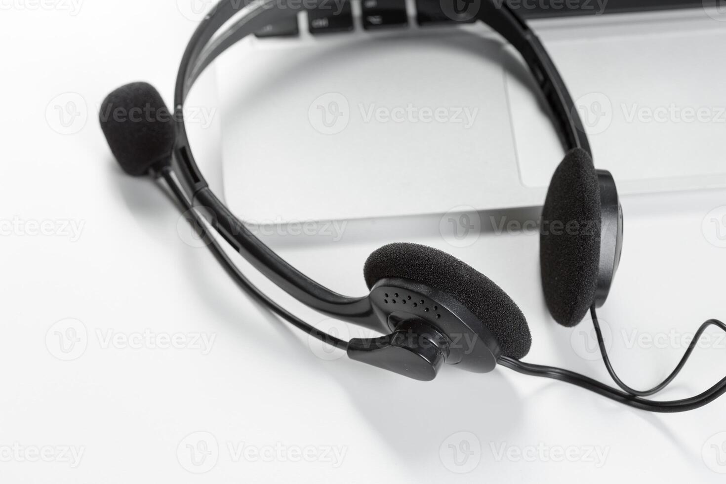 call center support concept. headset on keyboard computer laptop photo