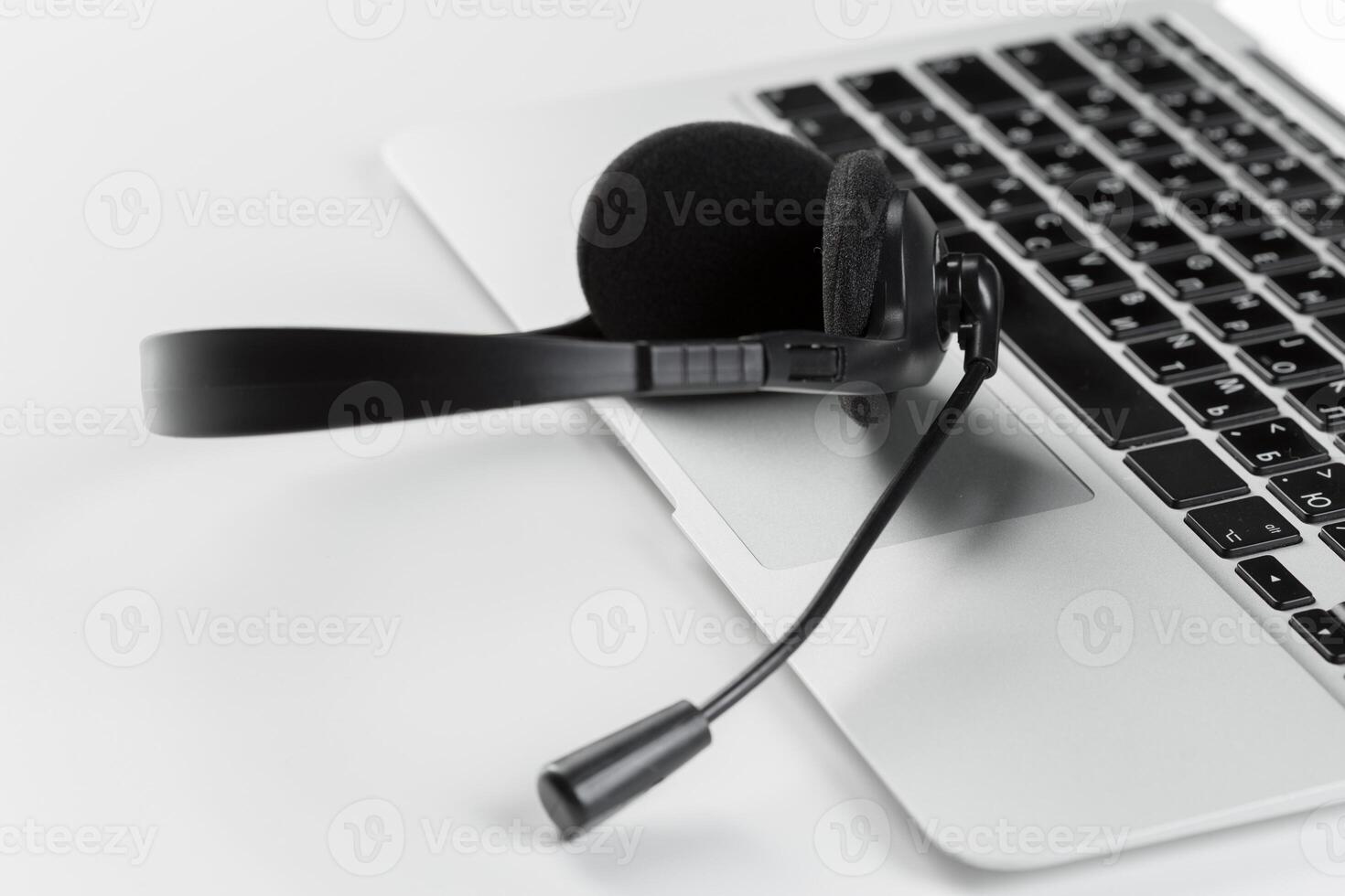 call center support concept. headset on keyboard computer laptop photo