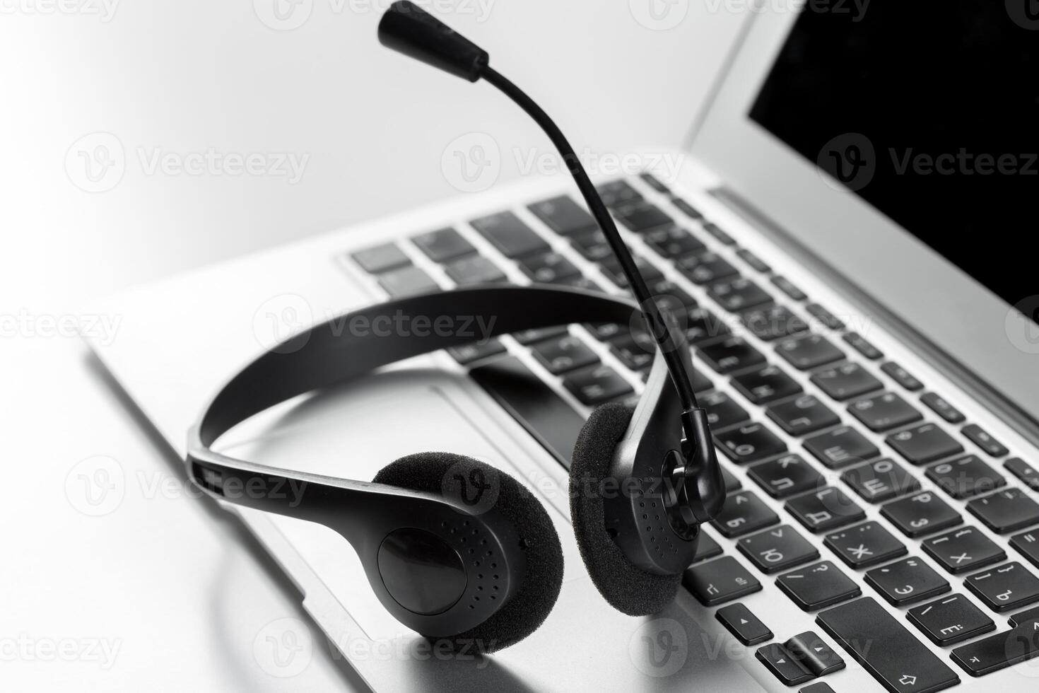 call center support concept. headset on keyboard computer laptop photo
