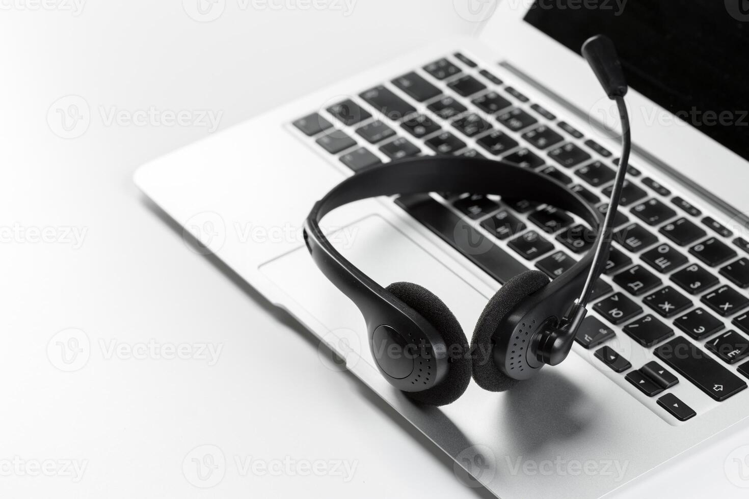 call center support concept. headset on keyboard computer laptop photo
