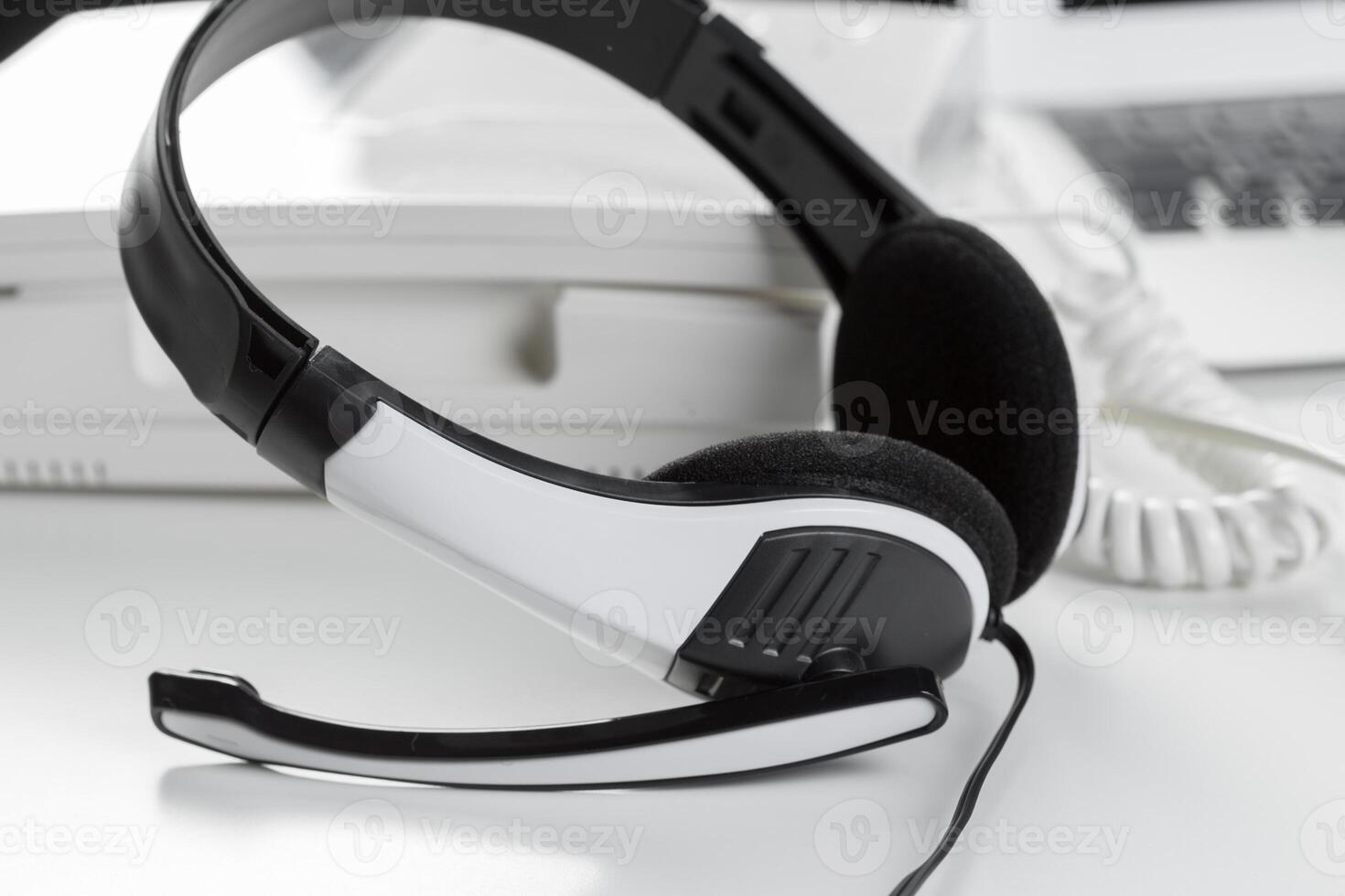 call center support concept. headset on keyboard computer laptop photo
