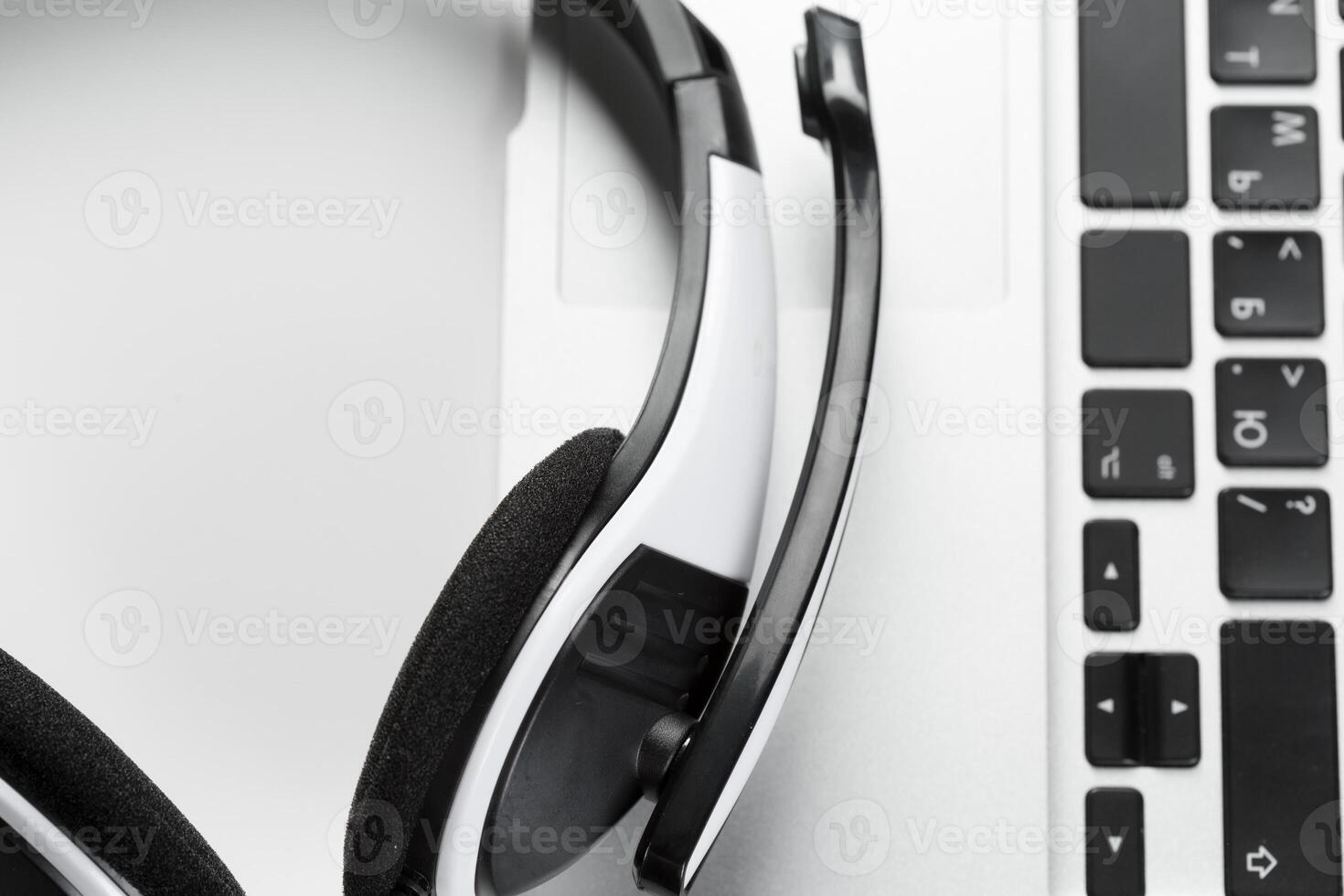 call center support concept. headset on keyboard computer laptop photo