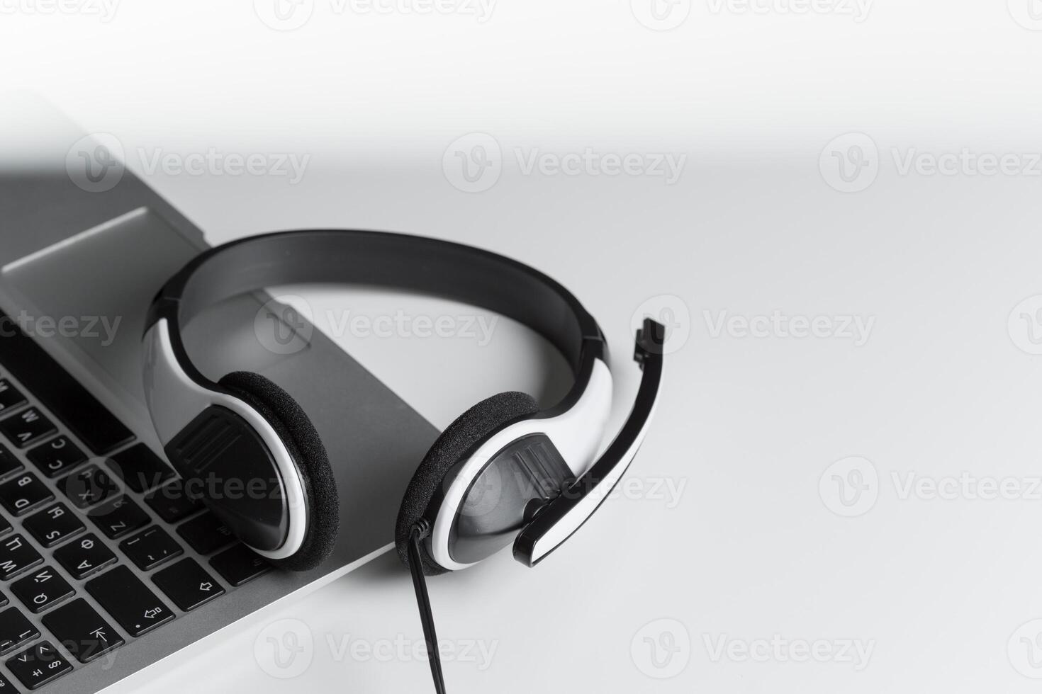 call center support concept. headset on keyboard computer laptop photo