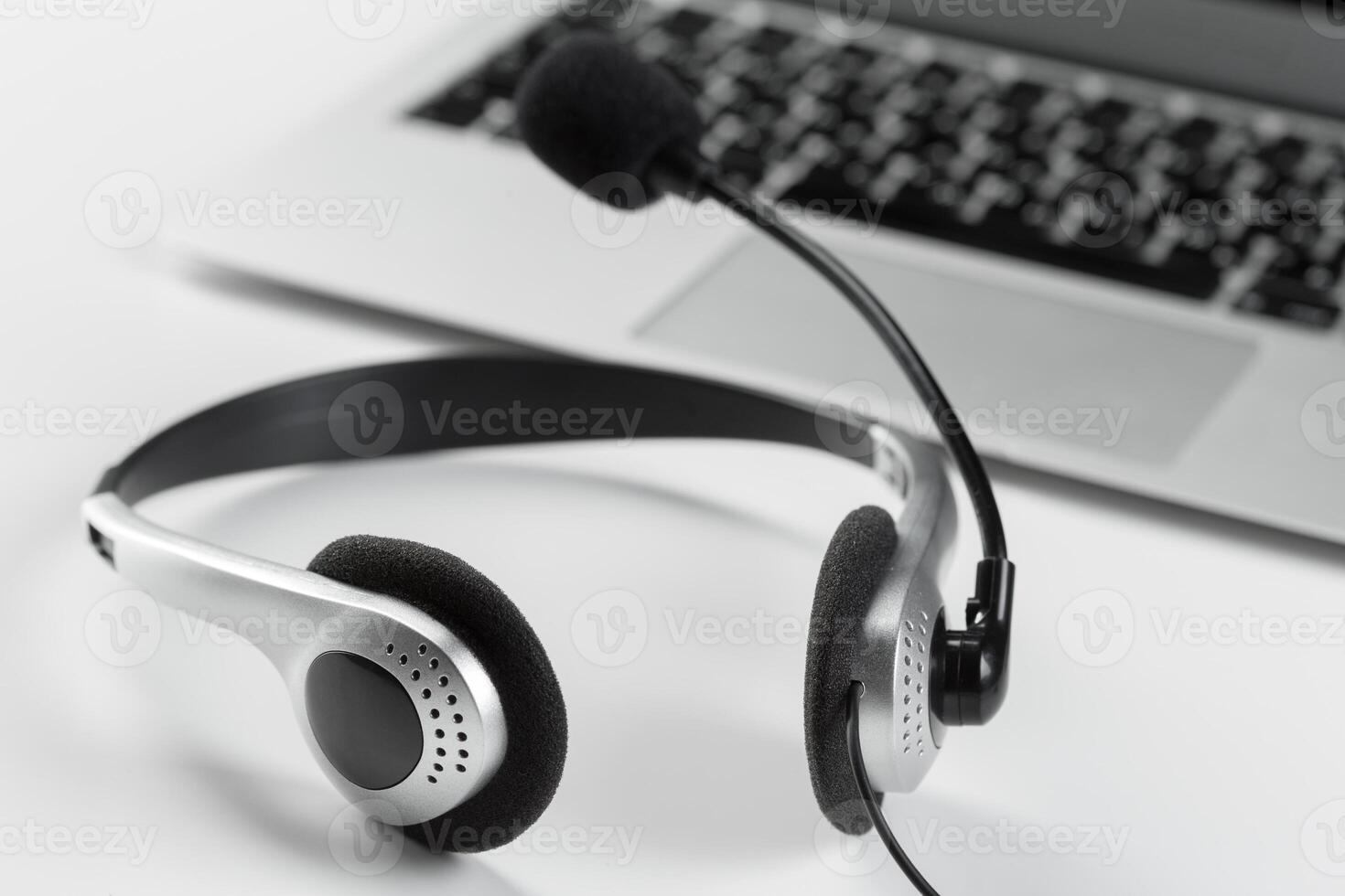 call center support concept. headset on keyboard computer laptop photo