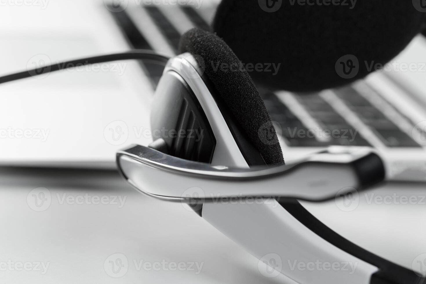 call center support concept. headset on keyboard computer laptop photo