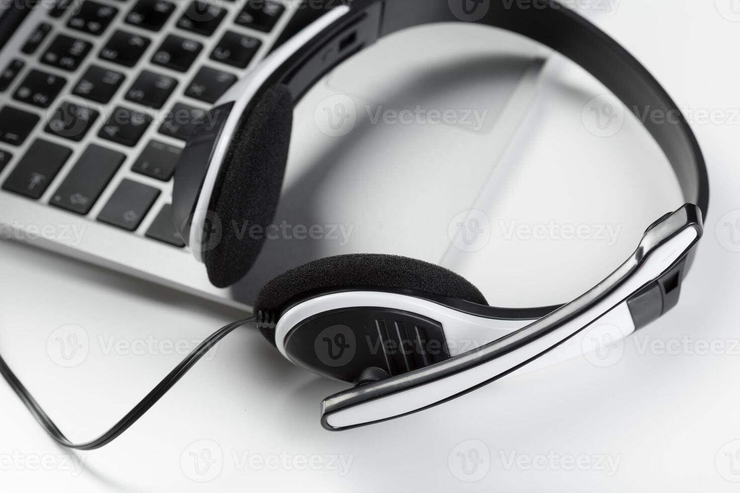 call center support concept. headset on keyboard computer laptop photo