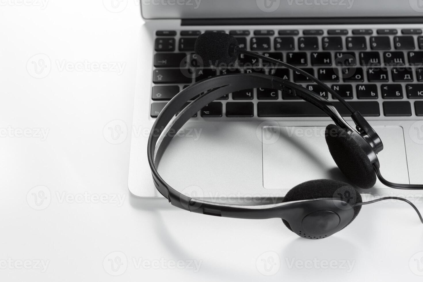 call center support concept. headset on keyboard computer laptop photo