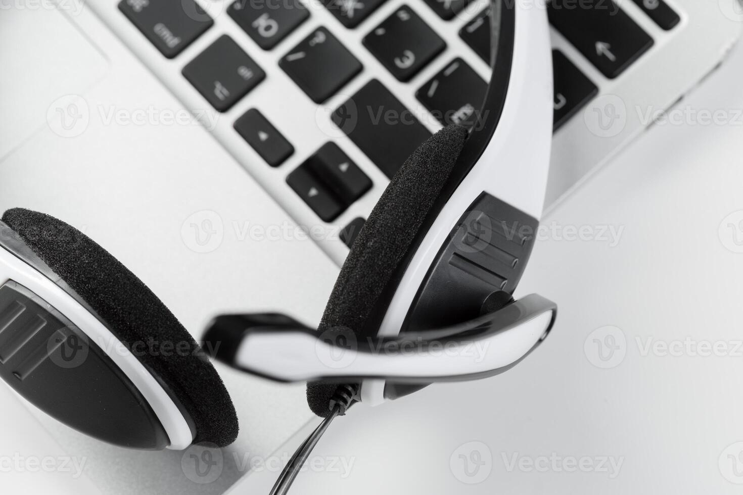 call center support concept. headset on keyboard computer laptop photo