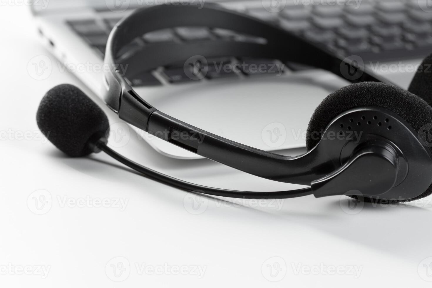 call center support concept. headset on keyboard computer laptop photo