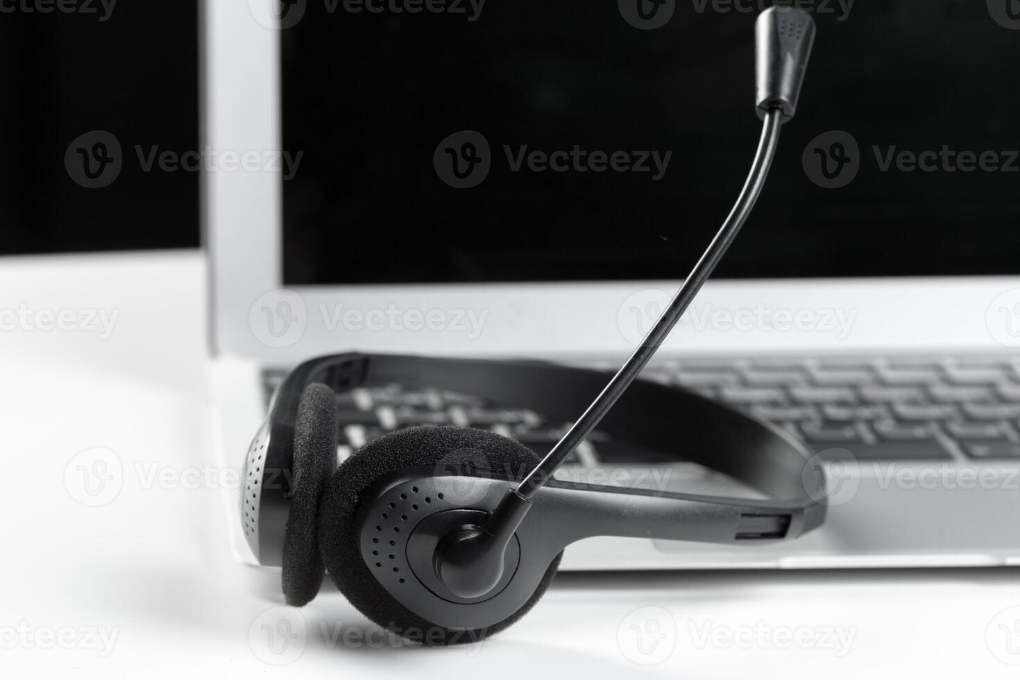 call center support concept. headset on keyboard computer laptop photo