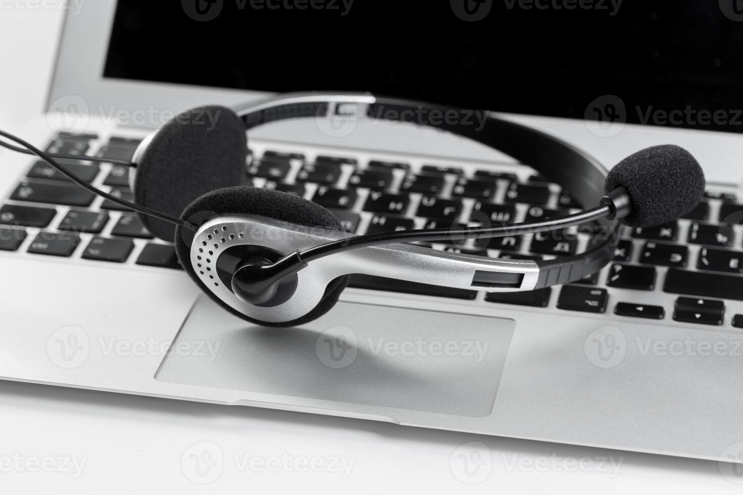 call center support concept. headset on keyboard computer laptop photo