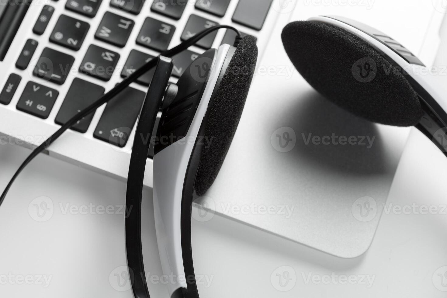 call center support concept. headset on keyboard computer laptop photo
