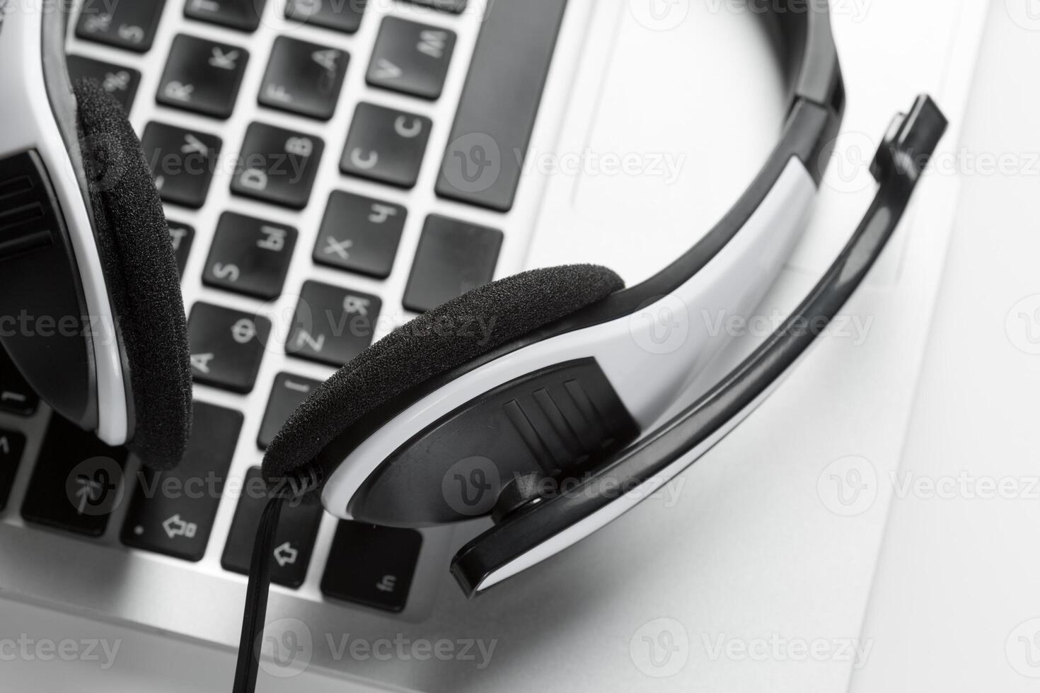 call center support concept. headset on keyboard computer laptop photo