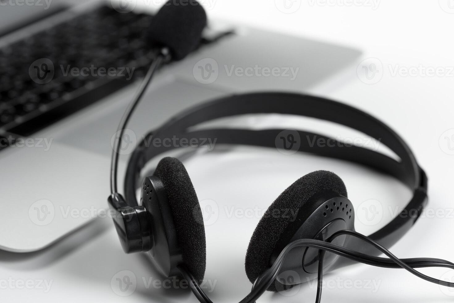 call center support concept. headset on keyboard computer laptop photo