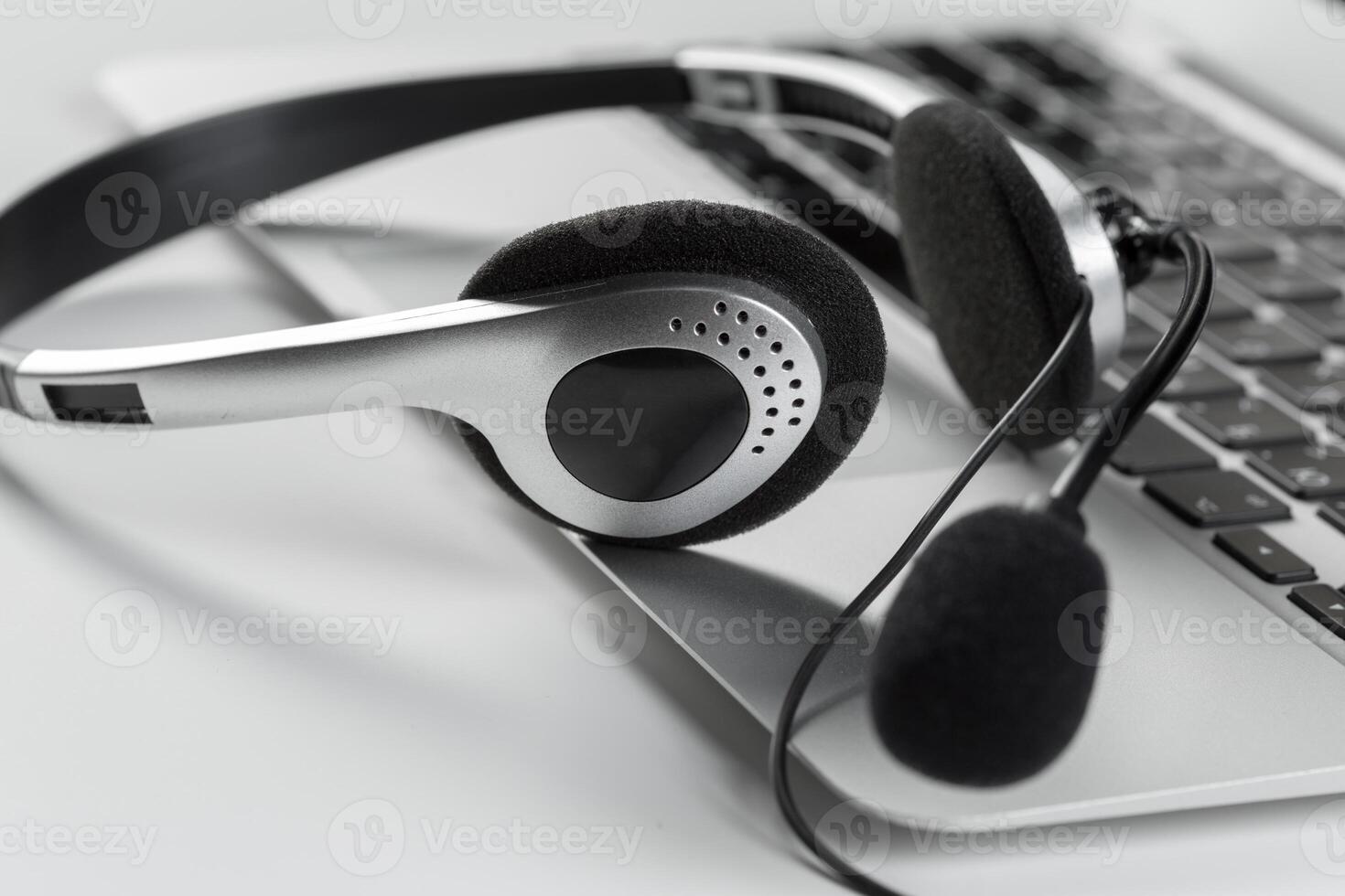 call center support concept. headset on keyboard computer laptop photo