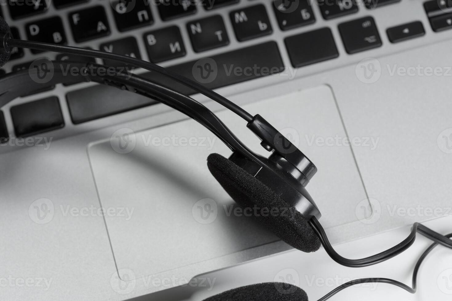 call center support concept. headset on keyboard computer laptop photo