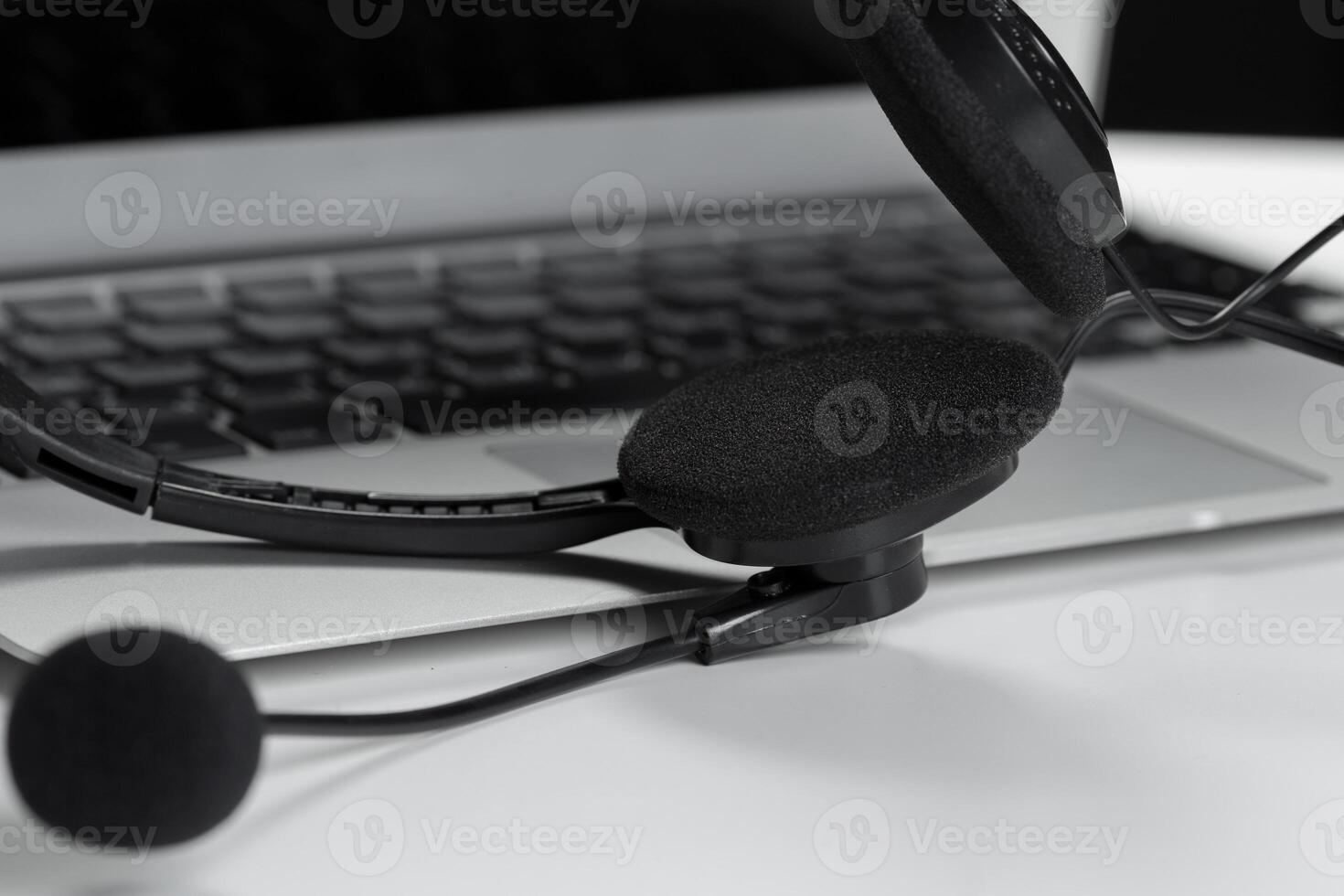 call center support concept. headset on keyboard computer laptop photo