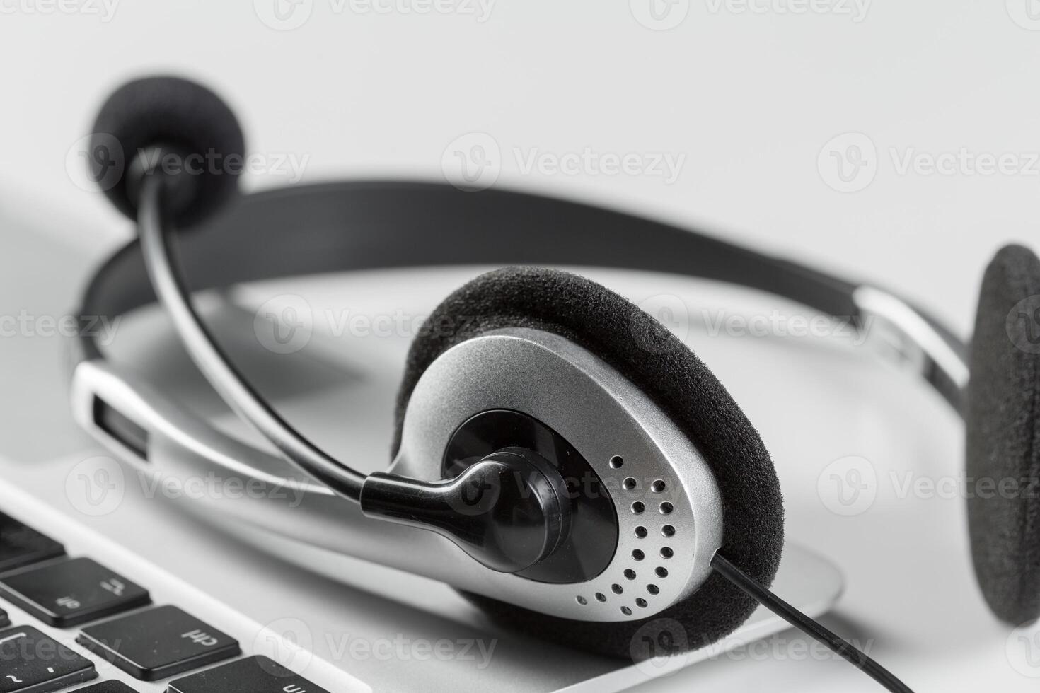 call center support concept. headset on keyboard computer laptop photo