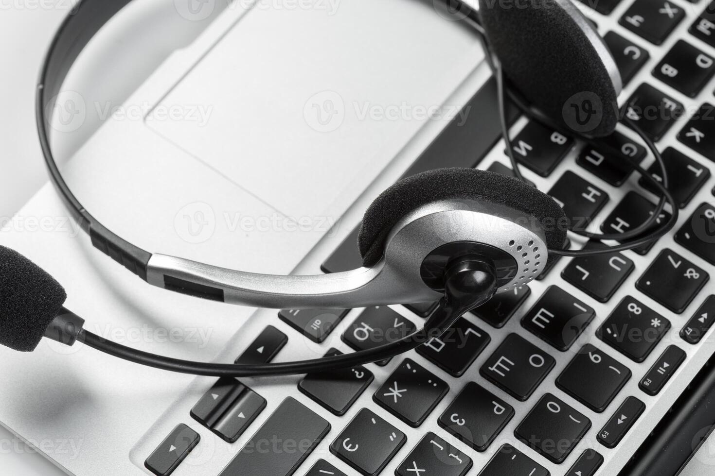 call center support concept. headset on keyboard computer laptop photo