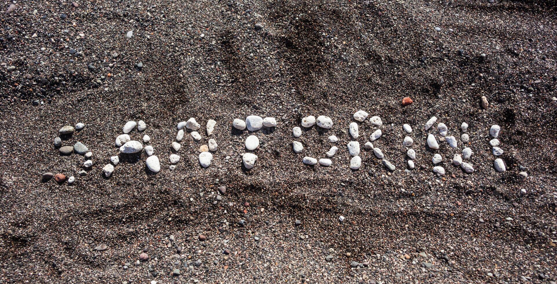 Text Santorini made with pumice stones photo
