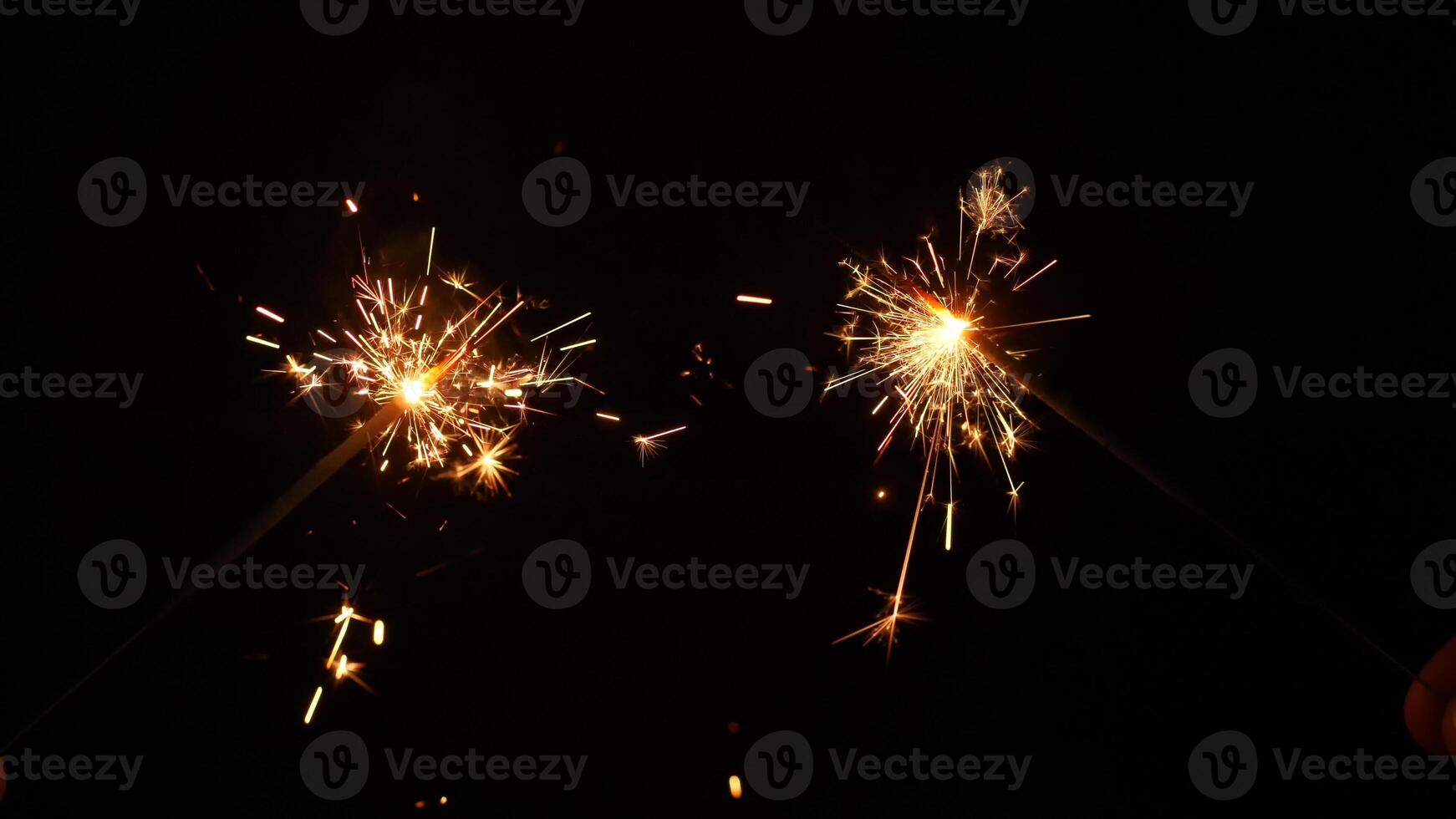 Sparkling stars burning on black background. Movie suitable to satisfy celebrations and holidays. photo