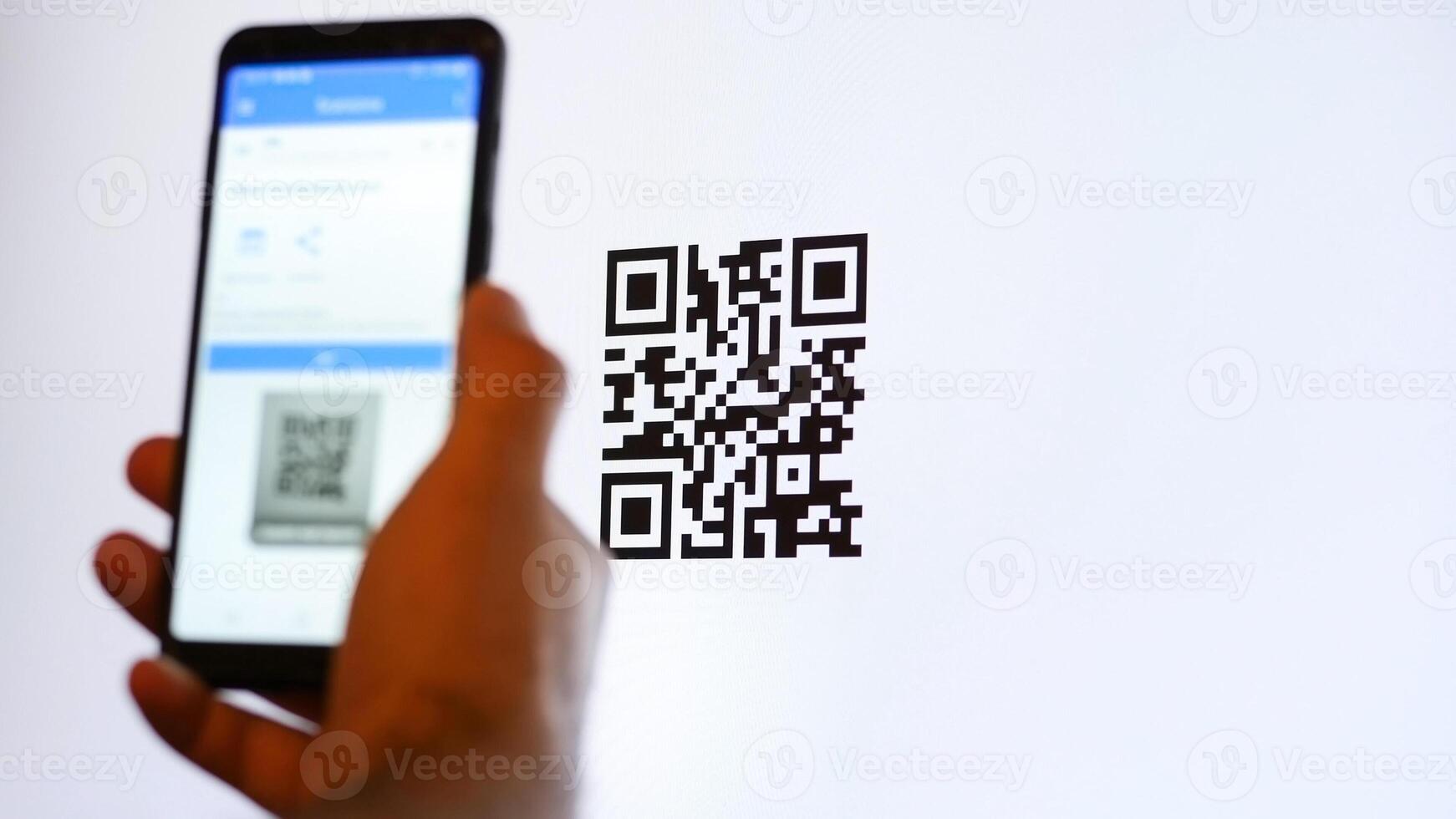 Scan QR code with smartphone on computer monitor. photo