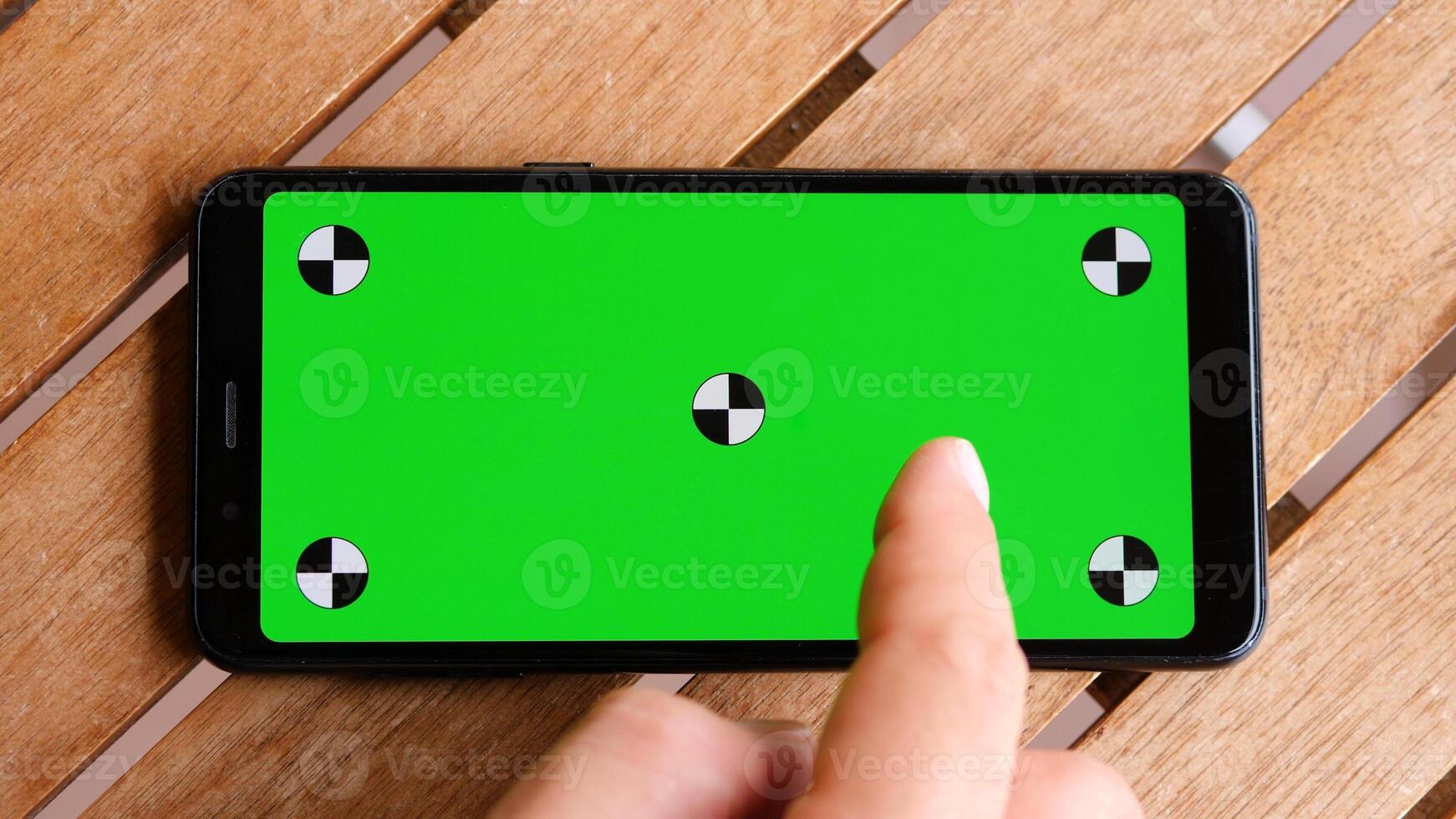 Top view smart phone place on table wood with green screen and markers. photo