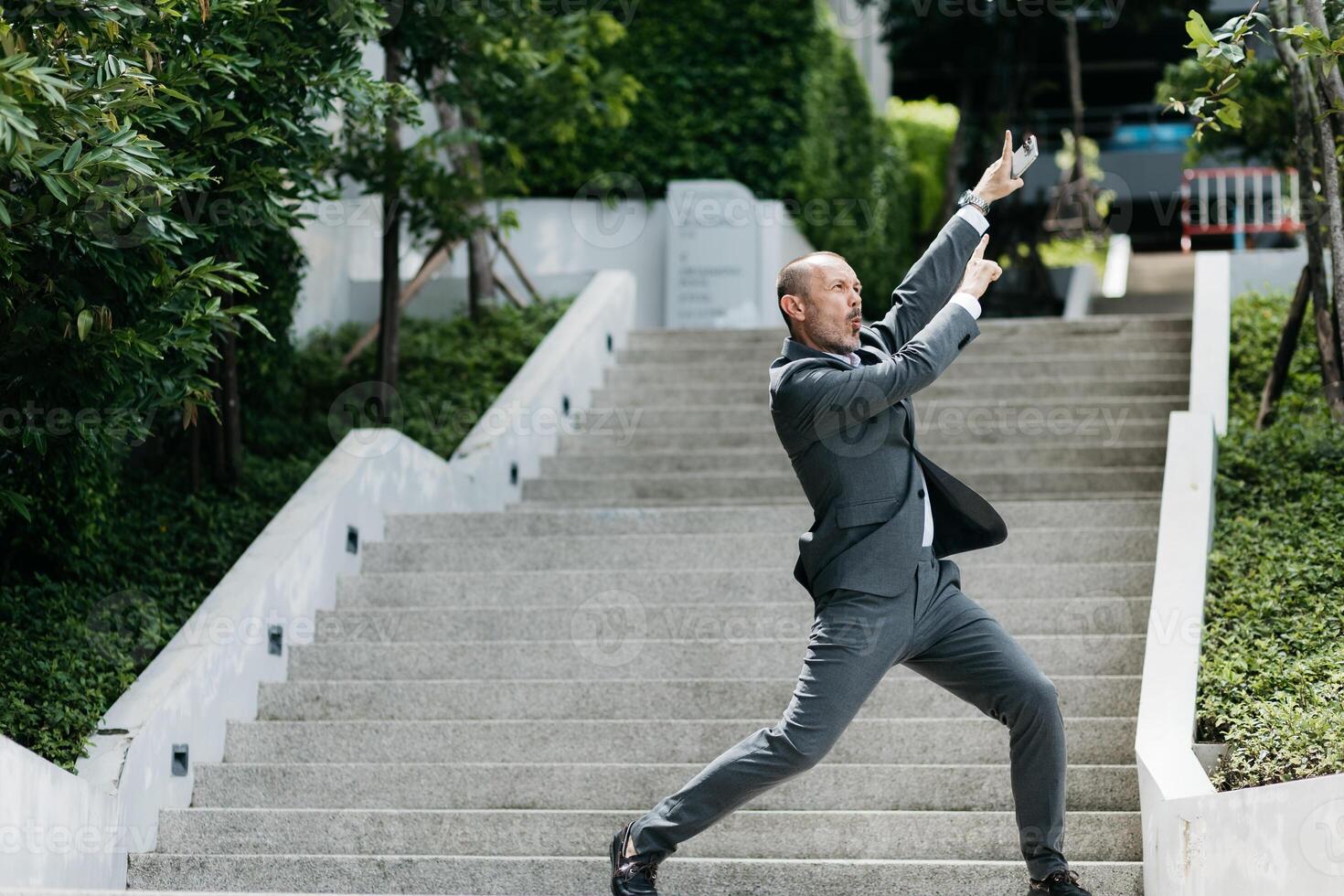 Businessman jumping in the street. Receiving joyful news about a deal completion. Business Ambitions concept. Goal business success strategy. Creative growth development. photo