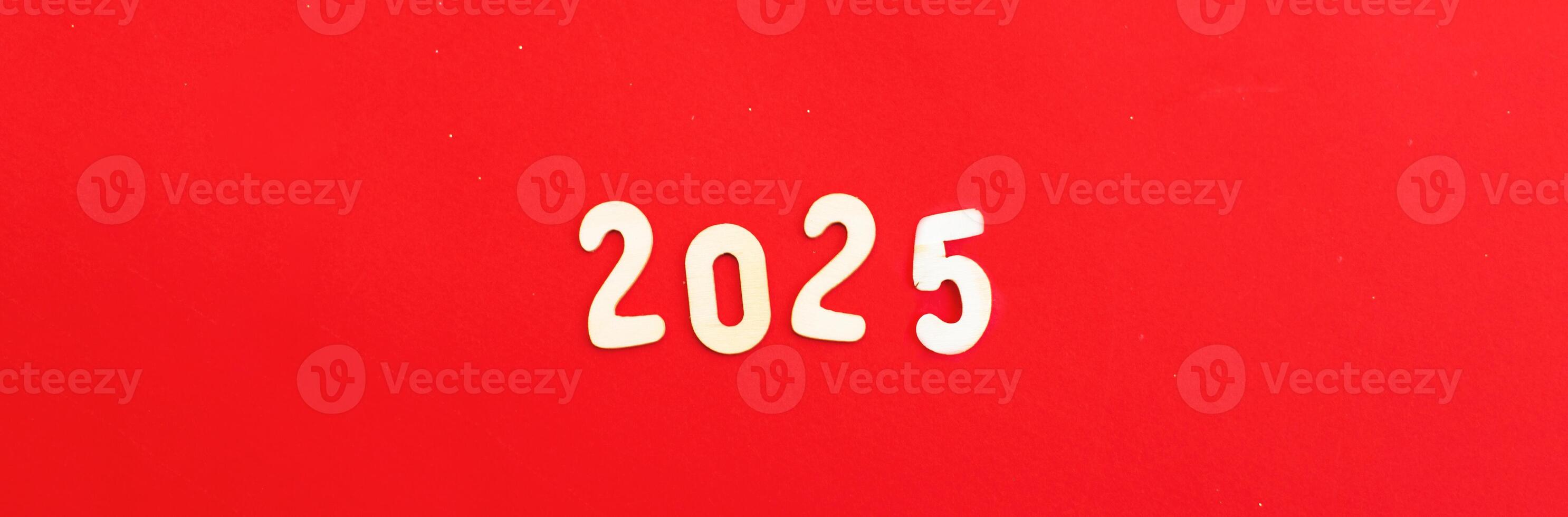 wooden Numbers 2025 on red background .Festive concept photo