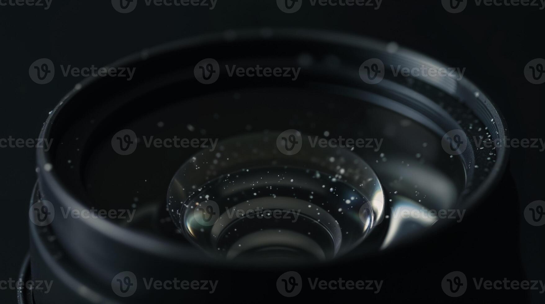 Camera lens with reflections and dust particles, close-up photo