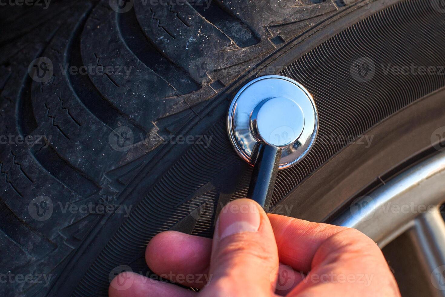 Stethoscope checking tire tread for inspection photo