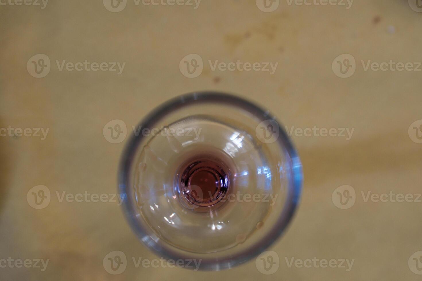 glass wine glass seen from above with a residual bottom of red wine in an Italian bar photo