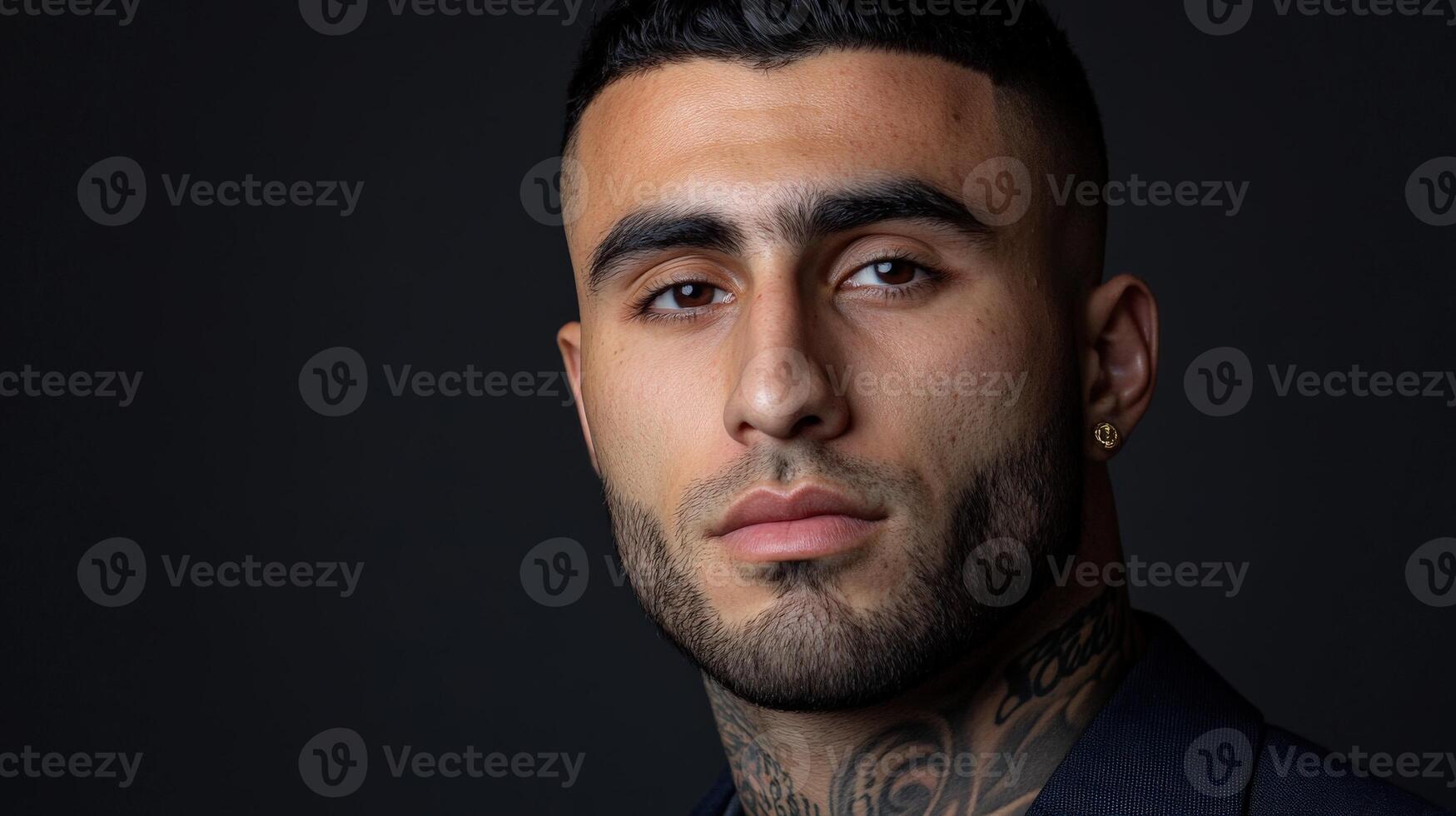 Tattooed man in stylish attire, dynamic pose, dark background photo