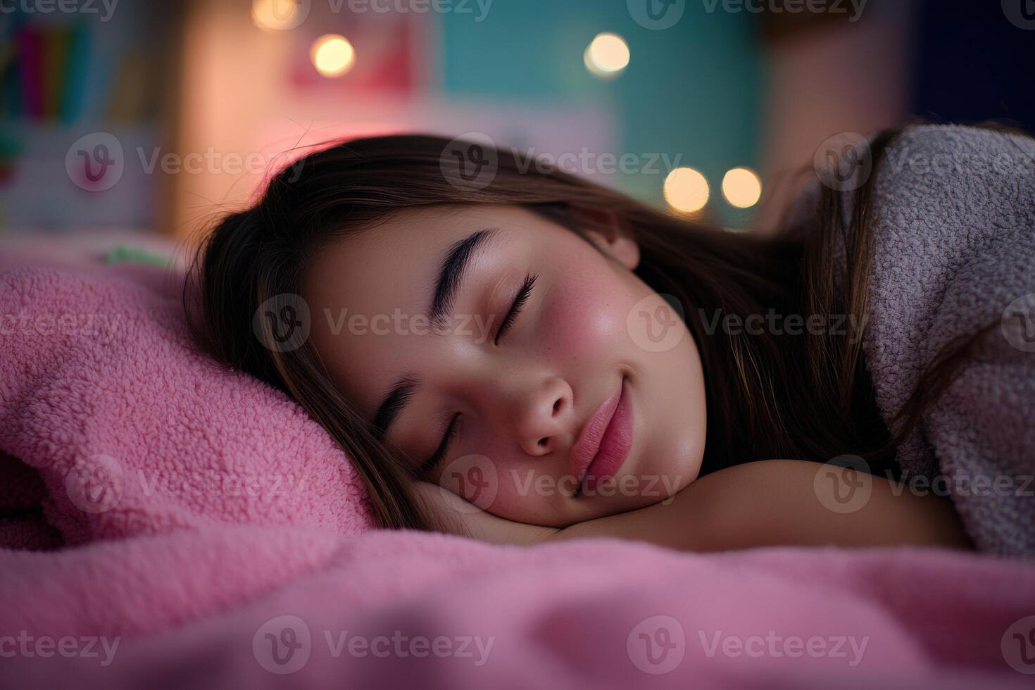 Young girl sleeping peacefully on a cozy bed surrounded by soft blankets photo