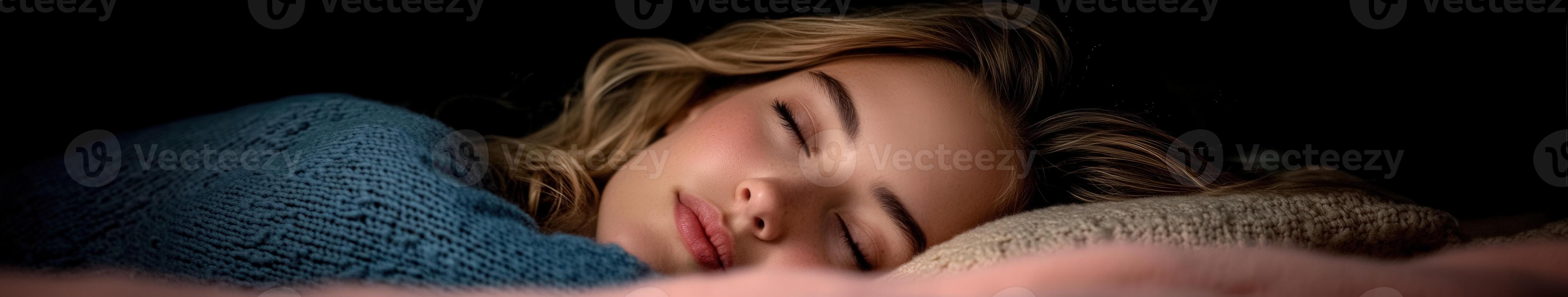 A young woman peacefully sleeping with gentle light at night photo